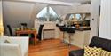 Penthouse kitchen opening to light/spacious lounge