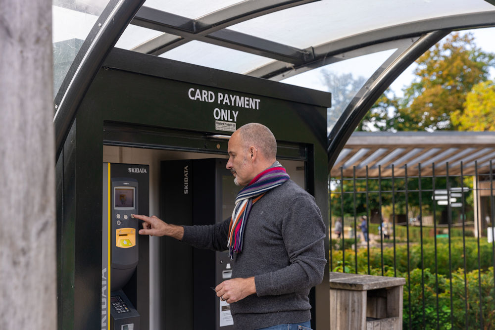 Man at pay station at Virginia Water